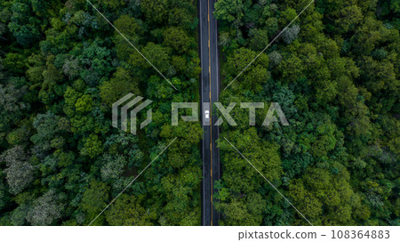 Aerial view over forest road with asphalt road and forest, Road in the middle of the forest up to mountain, Countryside road passing through the green forrest and mountain. Aerial view over forest road with asphalt road and forest, Road in the middle of the forest up to mountain, Countryside road passing through the green forrest and mountain. 108364883