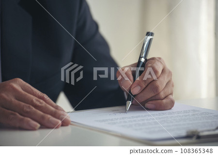 Asian business man using pen signing on new contract to starting projects in conference room. Close up manager businessman hands sign contract working meeting. Business agreement concepts. 108365348