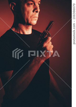 Gunman killer holding pistol artistic photo Gunman killer holding pistol artistic photo 108366070