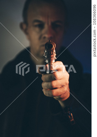 Gunman killer holding pistol artistic photo Gunman killer holding pistol artistic photo 108366096