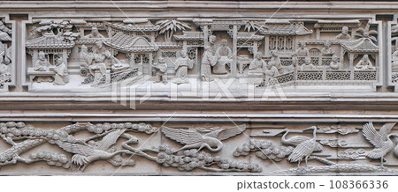 Richly carved stone bass-relief plaque on the doorway of the house in the Grand Canal, ancient town of Yuehe in Jiaxing, Zhejiang Province, China 108366336