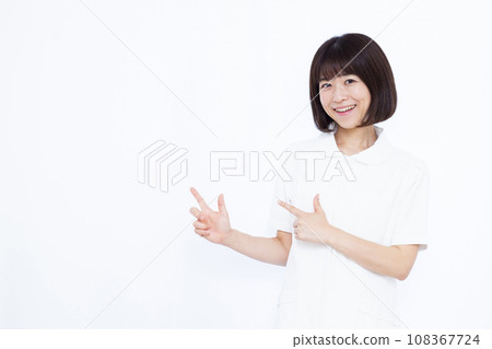 A nurse in her 30s giving an introduction in front of a white background A nurse in her 30s giving an introduction in front of a white background 108367724