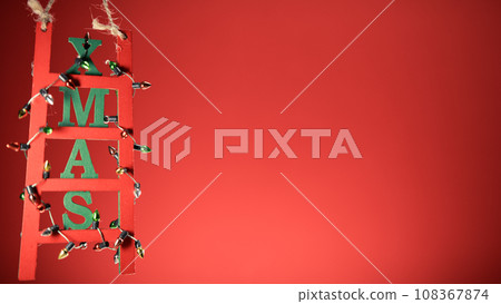 Christmas decoration ladder on red copy space background Christmas decoration ladder on red copy space background 108367874