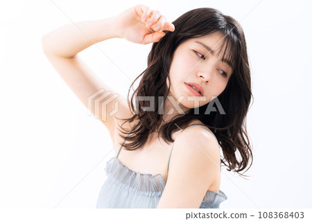 A middle-aged woman doing skin care against a white background A middle-aged woman doing skin care against a white background 108368403