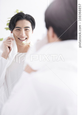 A refreshing man brushing his teeth A refreshing man brushing his teeth 108368857