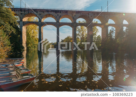 Railway Bridge with river in Bietigheim-Bissingen, Germany. Autumn. Railway viaduct over the Enz River, built in 1853 by Karl von Etzel on a sunny summer day. Bietigheim-Bissingen, Germany. Old 108369223