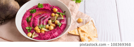 Homemade Beetroot hummus on white table, copy space 108369368