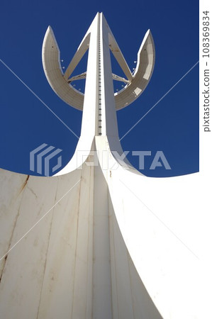 Montjuic tower shining against the blue sky Montjuic tower shining against the blue sky 108369834