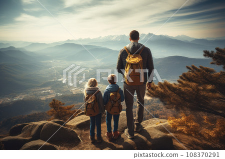 A family of travelers standing on top of a mountain A family of travelers standing on top of a mountain 108370291
