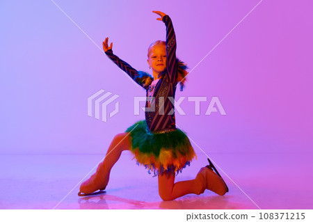 Talented, artistic, little girl, child in adorable dress dancing, performing figure skating against gradient pink purple background in neon light Talented, artistic, little girl, child in adorable dress dancing, performing figure skating against gradient pink purple background in neon light 108371215