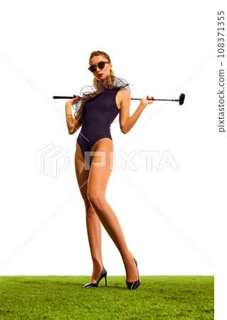 Full-length of beautiful, stylish young girl with slim body, in elegant bodysuit and heels posing with gold club isolated over white background Full-length of beautiful, stylish young girl with slim body, in elegant bodysuit and heels posing with gold club isolated over white background 108371355