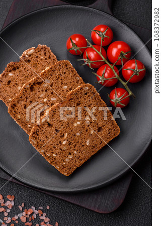 Delicious fresh crispy brown bread with seeds and grains Delicious fresh crispy brown bread with seeds and grains 108372982