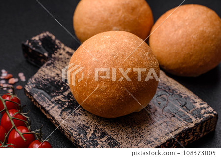 Delicious fresh crispy white round bread with seeds and grains Delicious fresh crispy white round bread with seeds and grains 108373005