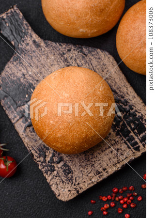 Delicious fresh crispy white round bread with seeds and grains Delicious fresh crispy white round bread with seeds and grains 108373006