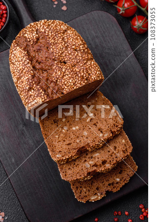 Delicious fresh crispy brown bread with seeds and grains 108373055