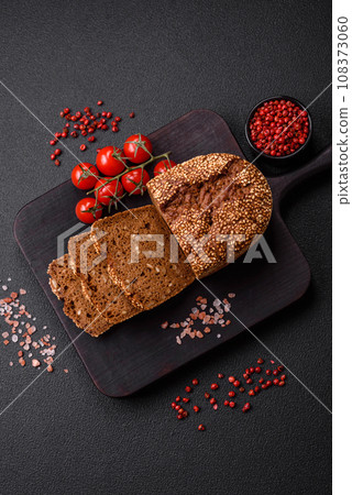 Delicious fresh crispy brown bread with seeds and grains Delicious fresh crispy brown bread with seeds and grains 108373060