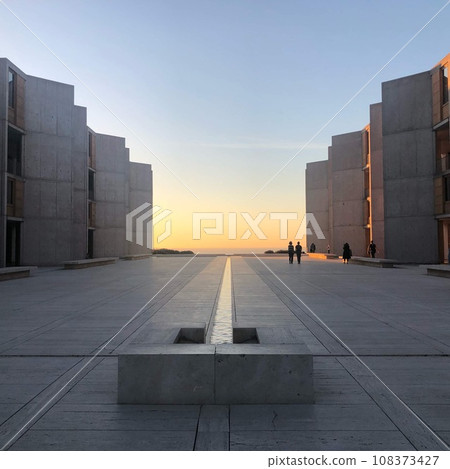 sunset seen between buildings 108373427