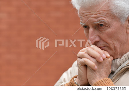 Portrait of an old man having a headache Portrait of an old man having a headache 108373865