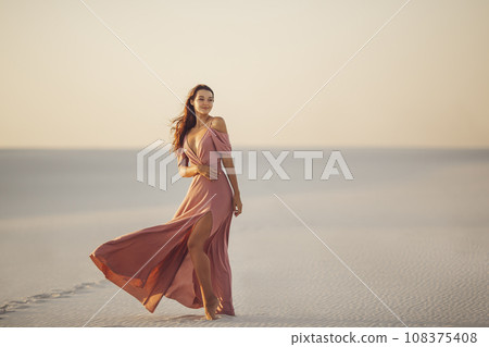 Travel in Desert Fashionable Woman Model in Evening Pink Dress Travel in Desert Fashionable Woman Model in Evening Pink Dress 108375408