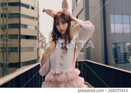 A girl wearing a costume at an amusement park A girl wearing a costume at an amusement park 108375913