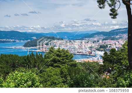 The view from the hill in Parque Monte del Castro, park located on a hill in Vigo, the biggest city in Galicia Region, in the North of Spain. View of the sea, houses and trees, selective focus 108375950