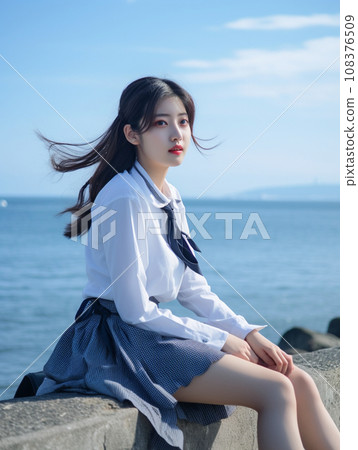 High school girl sitting on the beach High school girl sitting on the beach 108376509