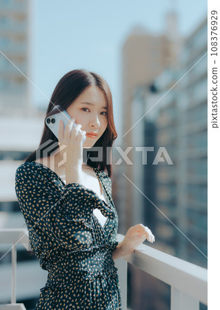 Scene of a young woman holding a smartphone 108376929