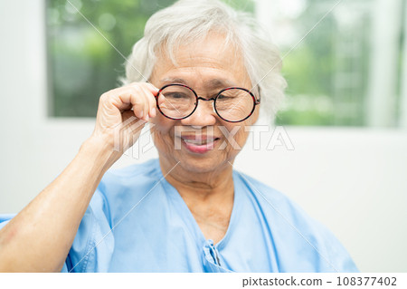 Asian senior woman wearing eyeglasses or vision glasses at home care service. Asian senior woman wearing eyeglasses or vision glasses at home care service. 108377402