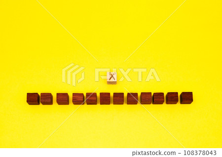 Yellow background with 12 red wood cubes separated by scissors 108378043