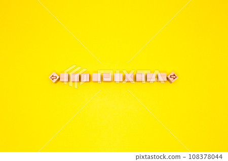Wood cube arrows pointing left and right with 10 blocks between them on a yellow background 108378044