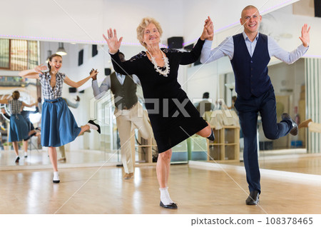 Mature woman dancing swing with young man Mature woman dancing swing with young man 108378465