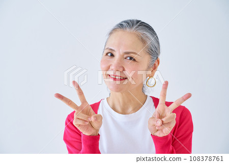 Senior woman doing a peace sign Senior woman doing a peace sign 108378761