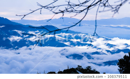 Aerial view over the mountains with sea of fog during morning sunrise in blue sky. Sea of clouds around mountain peaks at sunrise. Unseen travel in Northern Thailand. 108379511