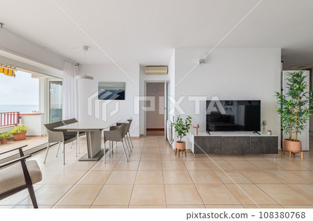 TV screen and empty dining table in comfortable apartment TV screen and empty dining table in comfortable apartment 108380768
