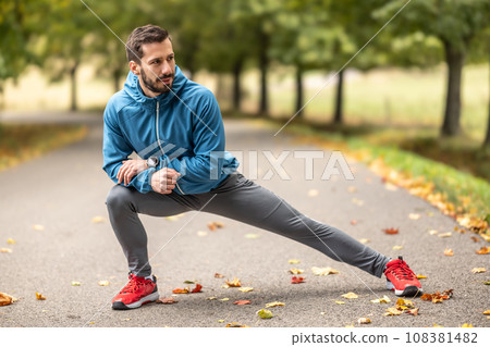 A young athlete is warming up before running training in the park A young athlete is warming up before running training in the park 108381482