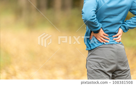 Young man with an athletic figure and a lower back injury. Back pain during sports. 108381508