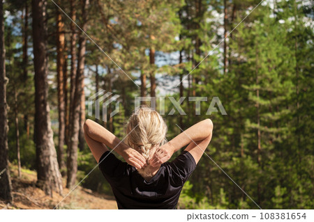 Beautiful woman against the background of a pine forest, forest baths, the idea of restoring health Beautiful woman against the background of a pine forest, forest baths, the idea of restoring health 108381654
