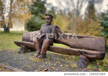 Valga, Estonia - October 22, 2023: Public bus waiting stops. Wooden sculptures as benches. Valga, Estonia - October 22, 2023: Public bus waiting stops. Wooden sculptures as benches. 108381964