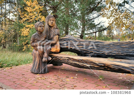 Valga, Estonia - October 22, 2023: Public bus waiting stops. Wooden sculptures as benches. Valga, Estonia - October 22, 2023: Public bus waiting stops. Wooden sculptures as benches. 108381968