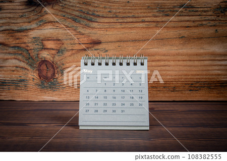 MAY 2024 cardboard desk calendar on a wooden texture background MAY 2024 cardboard desk calendar on a wooden texture background 108382555