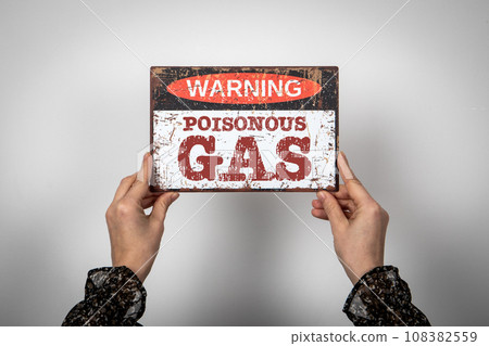 Poisonous Gas. Warning sign with text in the hands of a woman 108382559