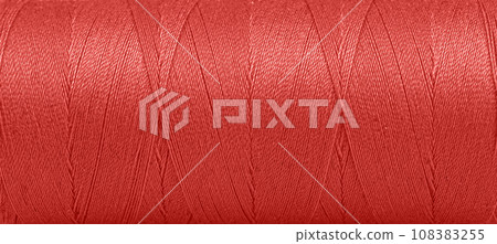Texture of threads in a spool of red color on a white background Texture of threads in a spool of red color on a white background 108383255