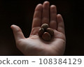 Hazelnuts in hand on a dark background. Close-up. 108384129