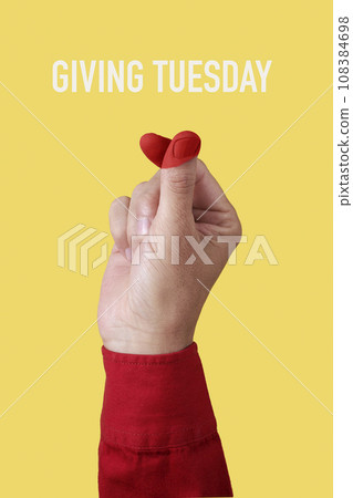 doing finger heart gesture and text giving tuesday 108384698