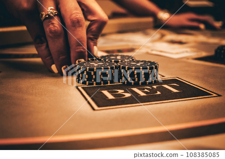 Dealer or croupier shuffles poker cards in a casino on the background of a table, chips. Concept of poker game, game business. Playing for money, a big win, a jackpot, gambling, a desire to get rich. Dealer or croupier shuffles poker cards in a casino on the background of a table, chips. Concept of poker game, game business. Playing for money, a big win, a jackpot, gambling, a desire to get rich. 108385085