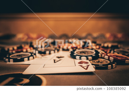 Dealer or croupier shuffles poker cards in a casino on the background of a table, chips. Concept of poker game, game business. Playing for money, a big win, a jackpot, gambling, a desire to get rich. Dealer or croupier shuffles poker cards in a casino on the background of a table, chips. Concept of poker game, game business. Playing for money, a big win, a jackpot, gambling, a desire to get rich. 108385092