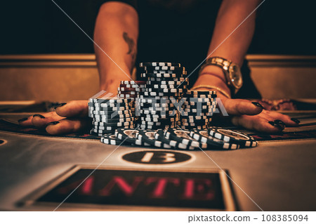 Dealer or croupier shuffles poker cards in a casino on the background of a table, chips. Concept of poker game, game business. Playing for money, a big win, a jackpot, gambling, a desire to get rich. Dealer or croupier shuffles poker cards in a casino on the background of a table, chips. Concept of poker game, game business. Playing for money, a big win, a jackpot, gambling, a desire to get rich. 108385094