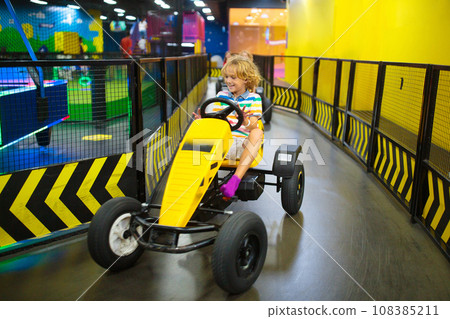 Kids on carting track. Go-kart fun for children. 108385211
