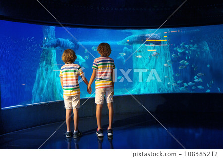 Family in aquarium. Kids watch fish, marine life 108385212