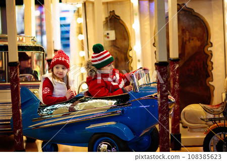 Kids at Christmas fair. Child at Xmas market. 108385623